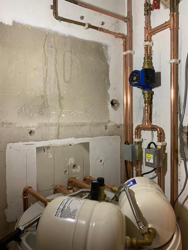 The same cylinder installation from above, with the pump and pipework on the wall